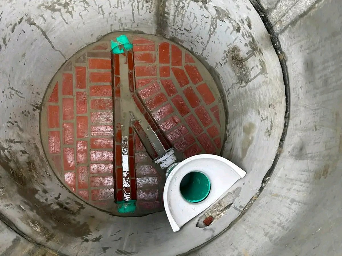 Sewer structure cleaned back to a clear brick invert after a main line cleaning by Drain Polishers